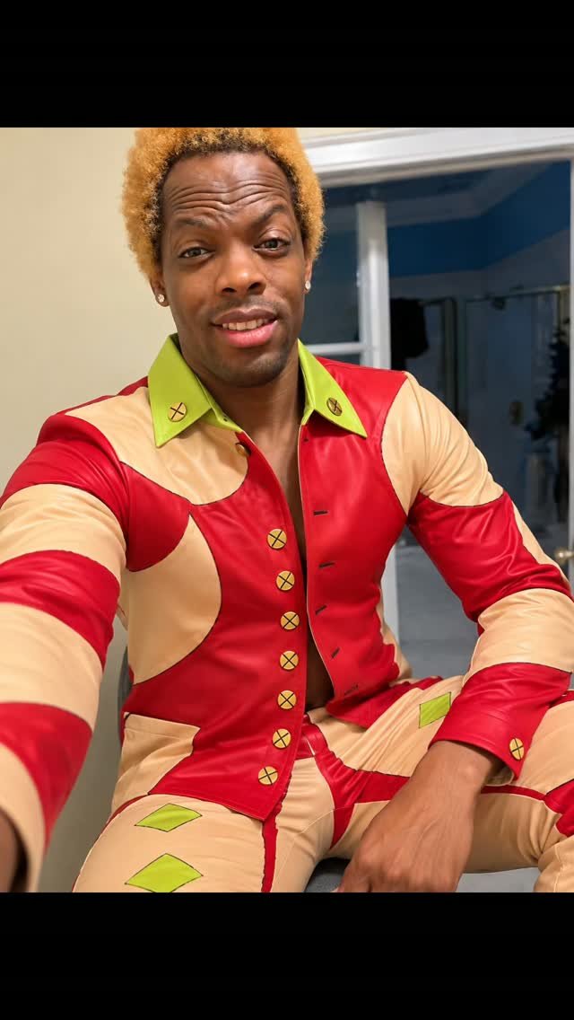 Jonathan Scott wearing the Royal Voltage Suit in red, cream, and lime